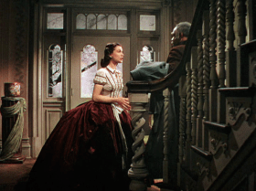 In the most girly red piped top, perfect hair, and a the gorgeous ball gown skirt that most "southern bells" don.