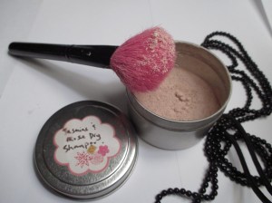 I keep my dry shampoo in a tin and dust it into my hair with a blush brush.  So easy, and fast too!